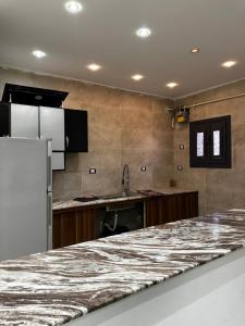 a kitchen with a large marble counter top at villa 578 in Sheikh Zayed +52 photos