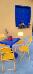 a blue table and chairs and a blue door at Rancho cachoeira da Usina in Brumadinho