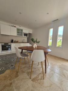 a kitchen and dining room with a wooden table and chairs at Domaine U Filanciu - Centru di Corsica in Moltifao
