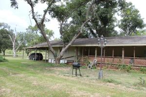 a house with a grill in front of it at Countryside Bliss - Entire Home on 2 Acres in Rosharon