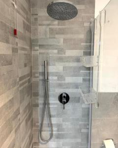 a shower with a shower head in a bathroom at ApartBergamo in Bergamo +10 photos