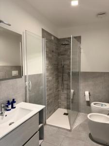 a bathroom with a shower and a sink and a toilet at ApartBergamo in Bergamo