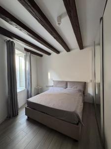 a bedroom with a large bed and wooden floors at ApartBergamo in Bergamo