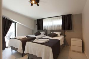 a hotel room with two beds and a window at Cesur Villa in Fethiye +20 photos