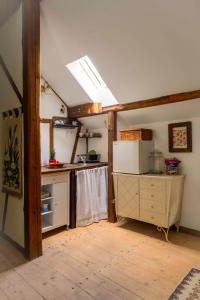 a kitchen with a stove and a refrigerator in a room at Dom Przytulisko in Janowiec +16 photos