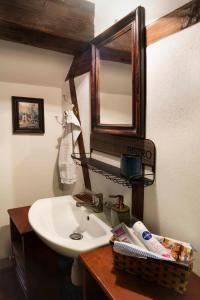a bathroom with a white sink and a mirror at Dom Przytulisko in Janowiec