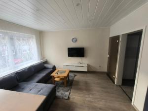 a living room with a couch and a tv at Mego in Werne an der Lippe