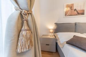 a bedroom with a bed with a curtain and a table at Dimora delle Vittorie - Vaticano in Rome