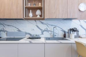 a kitchen with a sink and a counter top at Dimora delle Vittorie - Vaticano in Rome +13 photos