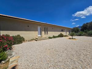 a building with a gravel driveway in front of it at Domaine U Filanciu - Centru di Corsica in Moltifao