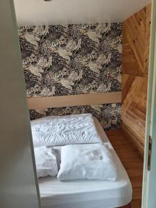 a bunk bed with two white pillows in a room at Entre campagne et forêt à 900m du zoo et au pied des pistes cyclables in La Flèche