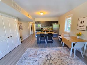a kitchen and living room with a table and chairs at Sandy Hill Downtown Guesthouse in Ottawa