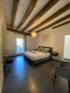 a bedroom with a bed and a table and a window at Appartement de charme L'écrin du Castel Classé 3 étoiles in Azay-le-Rideau