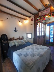 a bedroom with a bed with a blue comforter at Mancora Apartments in Máncora +154 photos