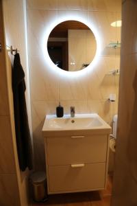 a bathroom with a white sink and a mirror at Appartement sous les combles Sony 29 in Grimentz