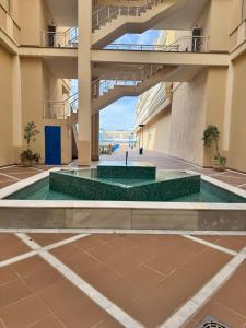 a building with a pool in a courtyard at HC Luxe in Seville