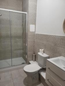 a bathroom with a shower and a toilet and a sink at Seaview Charm Herne Bay in Herne Bay +5 photos