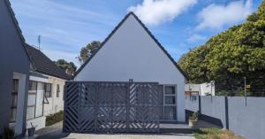 a gate to a house with a fence at Central Cottage Walmer in Gqeberha
