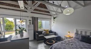 a bedroom with a bed and a couch in a room at Central Cottage Walmer in Gqeberha