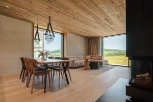a dining room with a table and chairs and a couch at 2Peaks Klínovec in Loučná pod Klínovcem