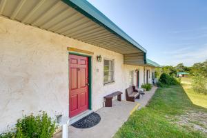 a red door on the side of a house at Hike, Fish and More Quaint Lake Whitney Retreat in Whitney