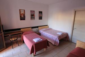 Postel nebo postele na pokoji v ubytování Albergo Roma