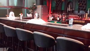 a bar with a row of chairs in a room at 7B Hotel in Addis Ababa