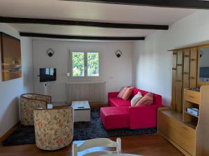 a living room with a red couch and a window at Apartment in Jardres