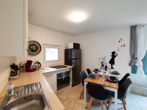 a kitchen with a table with chairs and a sink at Space House & Surprise - Disneyland & Paris in Chalifert +15 photos