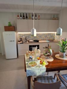 a kitchen with a wooden table with food on it at Podere Radici - Room & Breakfast in Misano Adriatico