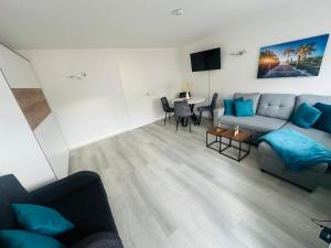 a living room with a couch and a table at Gemütliches Apartment im Schwarzwald, ruhig und zentral in Sankt Blasien in St. Blasien