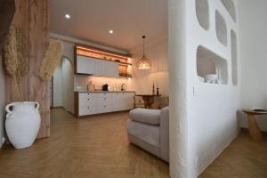 a living room with a couch and a kitchen at Residential complex New England in Kyiv