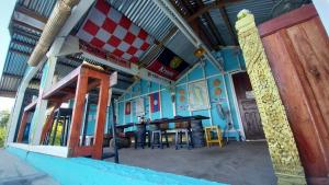 a restaurant with a table and chairs in a building at Don Som Riverside Guesthouse in Don Som