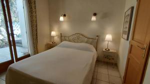 a bedroom with a white bed and two lamps at Gite Mimosa - Private Pool, Sainte-Valière, South of France in Sainte-Vallière +11 photos