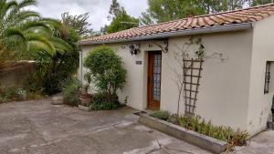 a small white house with a door at Gite Mimosa - Private Pool, Sainte-Valière, South of France in Sainte-Vallière