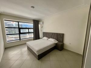 a bedroom with a bed and a large window at Mode Tanger app in Tangier