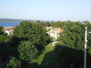 a view of a house with trees and the water at Berto in Nerezine