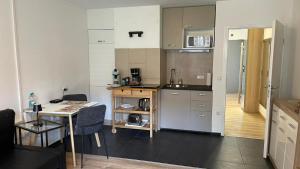 a small kitchen with a table and a table and a tableablish at Lindenhof Apartment 10 in Bad Aibling