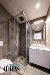 a bathroom with a glass shower and a sink at Blue Horizon Apt at Λαγονήσι 6ppl in Kalívia Thorikoú