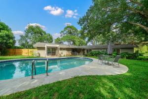 a swimming pool in front of a house at Relaxing, Cozy 3BR Pool Home with King Suite! in Ocala
