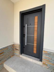 a large black door with a window on a building at OB DELUXE Apartments 3 in Accra