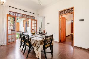 a dining room with a table and chairs at The Samdro Colombo in Colombo