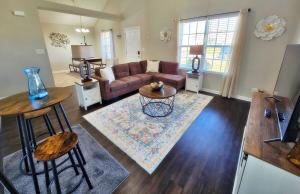 a living room with a couch and a table at Lg Deck-BBQ Grill - King Suite - Near RAFB in Bonaire