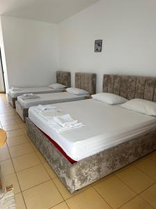 a row of four mattresses sitting in a room at Hotel JF Dhërmi in Dhërmi