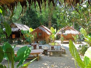 a park with benches and huts in a forest at Khai jungle wassanacamp in Ban Thung Lang Tham