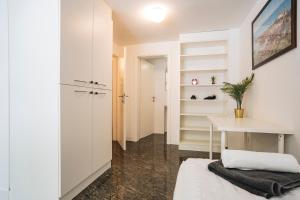 a white room with a desk and a table at LightBox Central in Ljubljana +14 photos