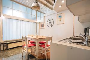 a kitchen with a table and chairs in a room at LightBox Central in Ljubljana