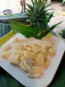 a plate of food with a pineapple on a table at Khai jungle wassanacamp in Ban Thung Lang Tham