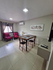 a living room with a table and chairs and a couch at COMPLEJO CRUZ in Alta Gracia +18 photos