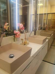 a bathroom with two sinks and two mirrors at Dream House in Ananindeua +16 photos